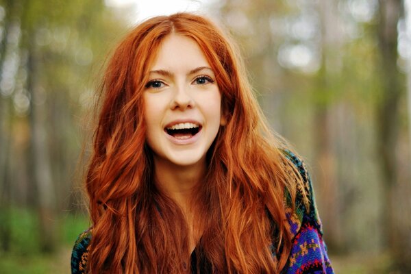 Beautiful red-haired girl with an unnatural smile