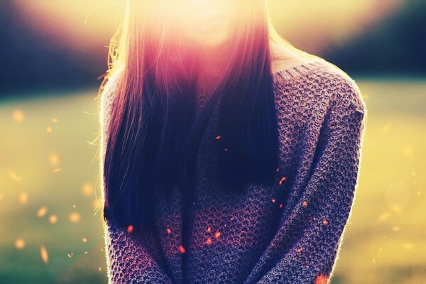 A girl in a field against a background of green grasses