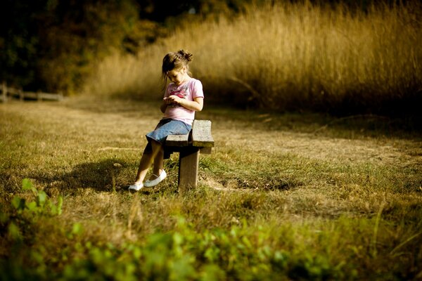 Chica al aire libre sentado en un banco