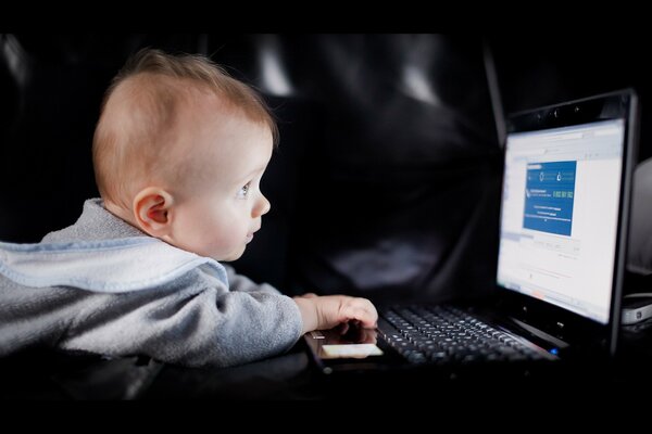 Petit enfant devant un ordinateur portable