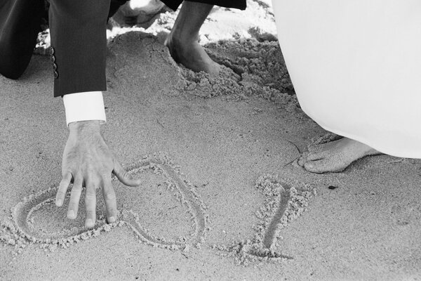 Healing black and white photo of the feet of the newlyweds