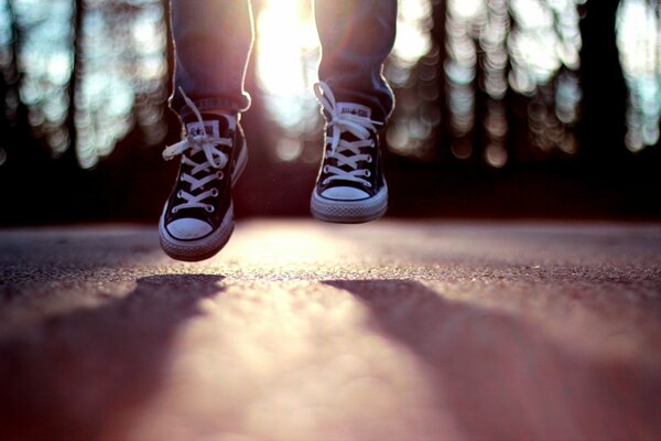 Jump in sneakers in the sun