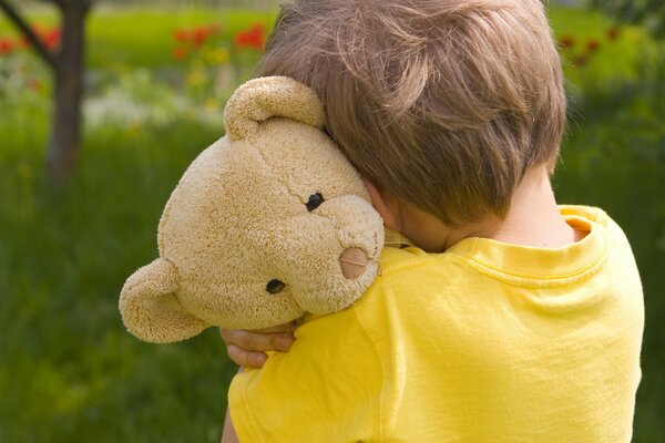 A little boy with a sad bear