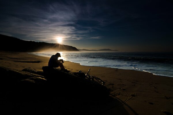 Photographer on the background of the sea dawn