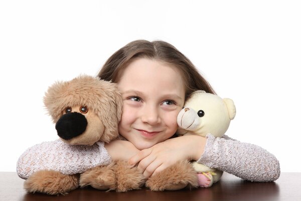 A girl hugs teddy bears