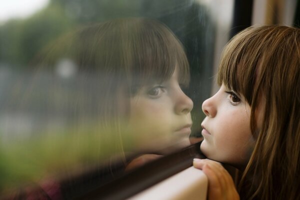 Little girl reflection in the window