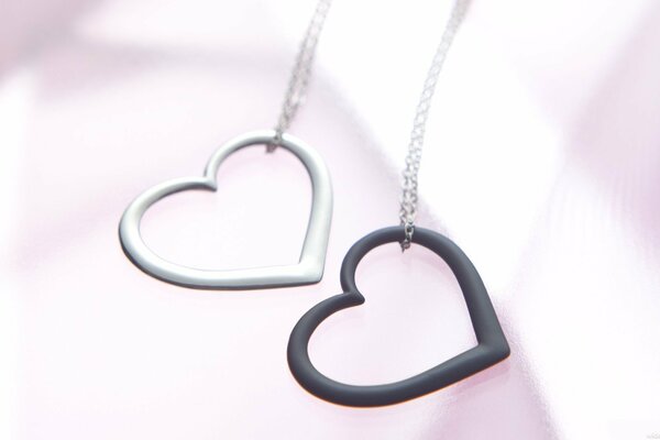 Two pendants in the form of a black and white heart