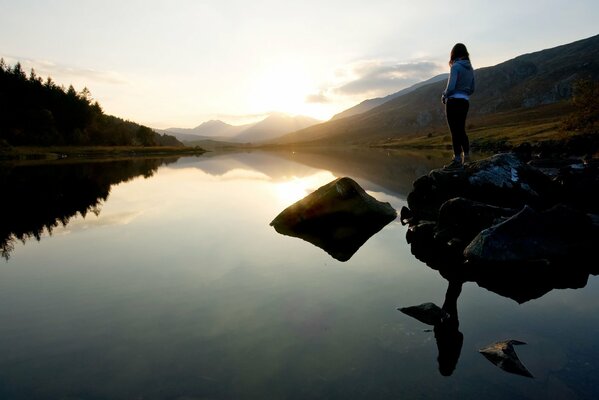 A lonely girl admires the sunset