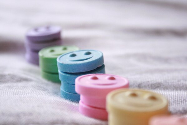 Bonbons multicolores avec un sourire sur une nappe