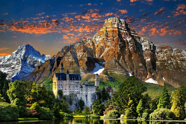 Landscape with a view of Neuschwanstein in the mountains with a sunset sky