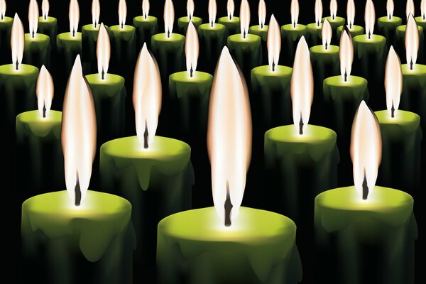 Un montón de velas verdes ardientes