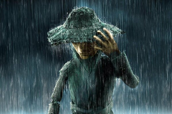 A man in the rain with a hat