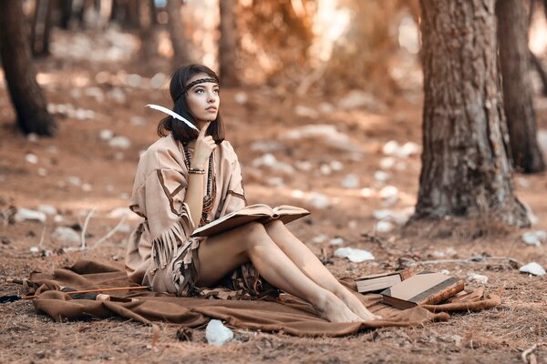 A girl with a pen reads a book