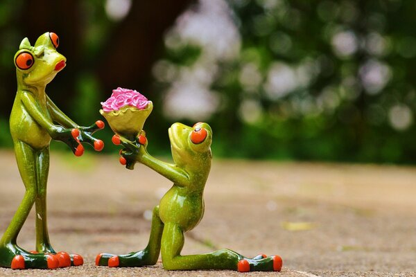 Marriage proposal of frog figurines