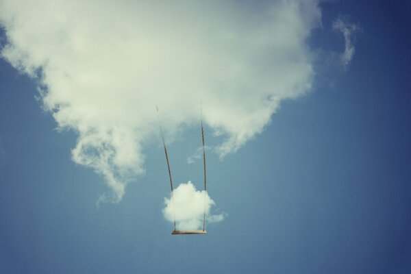 Swing from a cloud in a blue sky