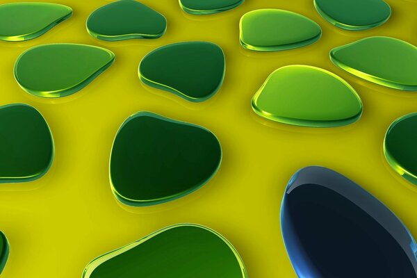 Grüne Glastropfen auf gelber Oberfläche