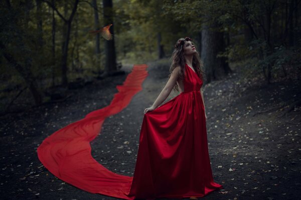 Beautiful girl in a red floor-length dress