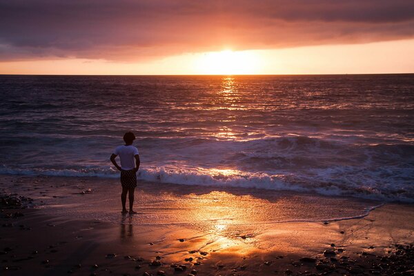 A man watching the sunset on the seashore