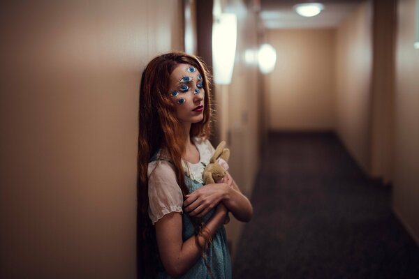 Long-haired girl with a bunny toy