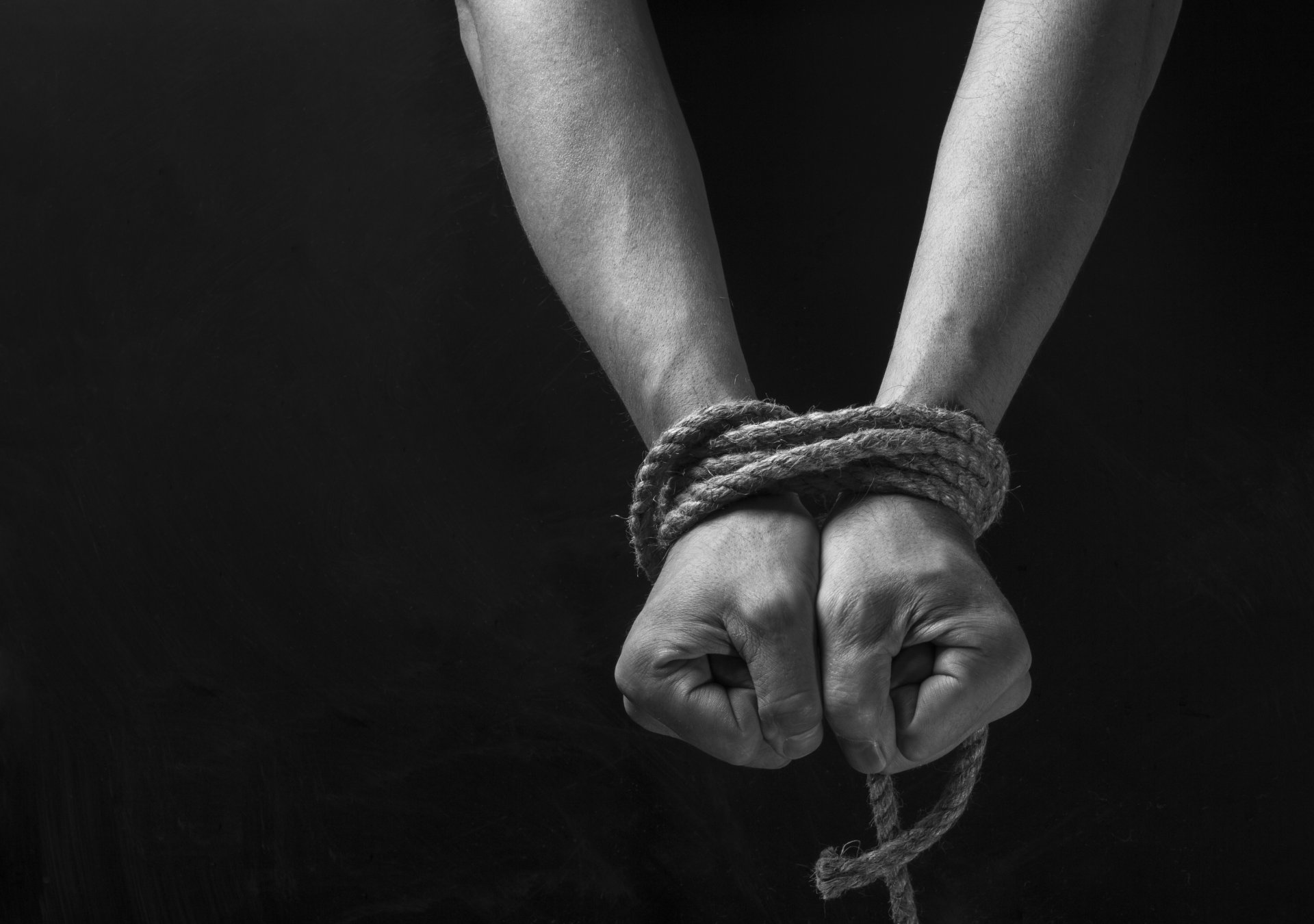 ropes shackles hands background black