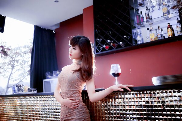 Asian girl with a glass of wine
