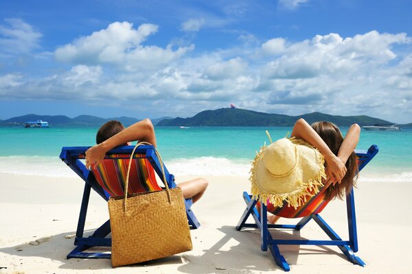 Relaxing on a sun lounger on the beach by the sea