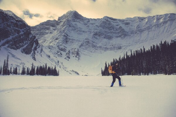 A skier with a backpack alone in the mountains