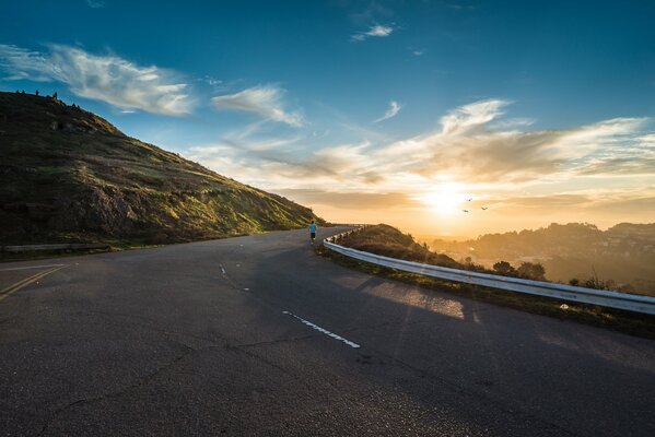 Jogging on the road in the morning at dawn