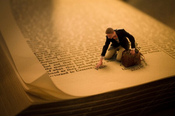 Figure of a man on a book