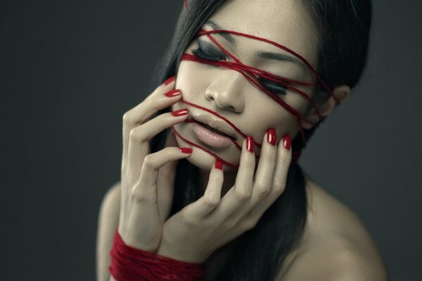 Portrait of an Asian woman with red accents