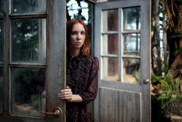 A woman s gaze through gray doors