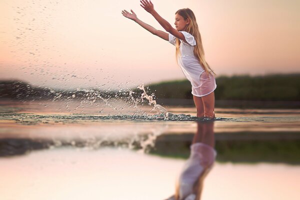 Young girl splashing in the water