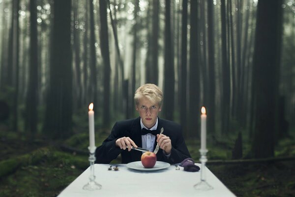 Guy eats apples by candlelight