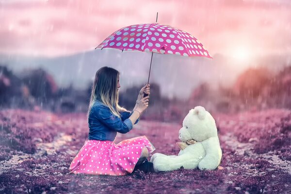 A girl with an umbrella and a Teddy bear