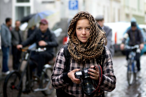 Young photographer outside in the rain