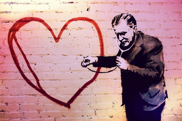 Graffiti que representa a un médico escuchando un corazón pintado