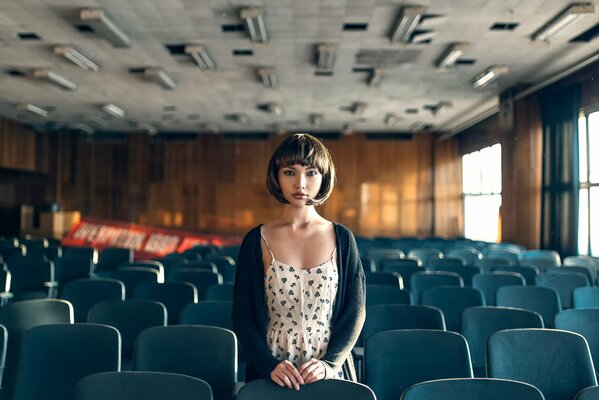 A girl in an empty auditorium