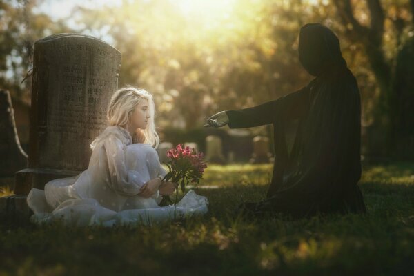 Mädchen im weißen Kleid auf dem Friedhof