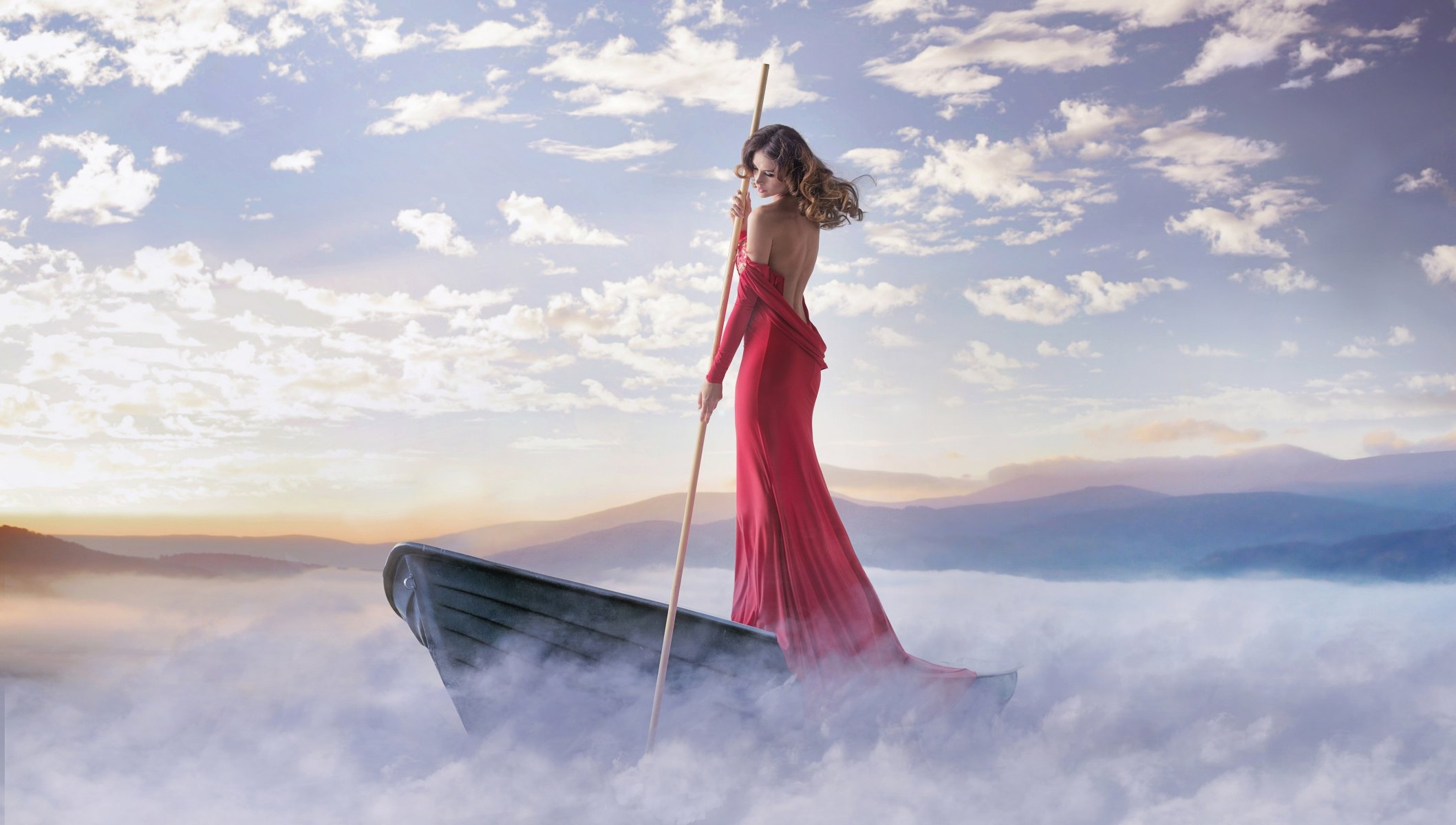 girl is in red dress pole boat fog clouds beach