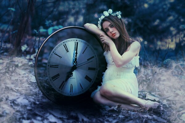 A girl in a white dress next to the clock