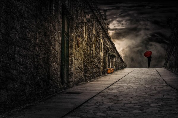 A girl with a bright umbrella walks down the street