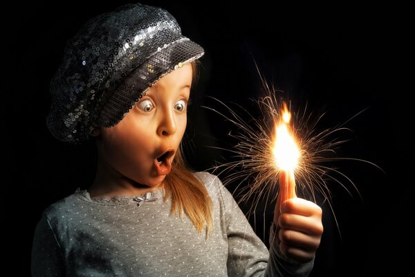 The girl is surprised by the lit candle