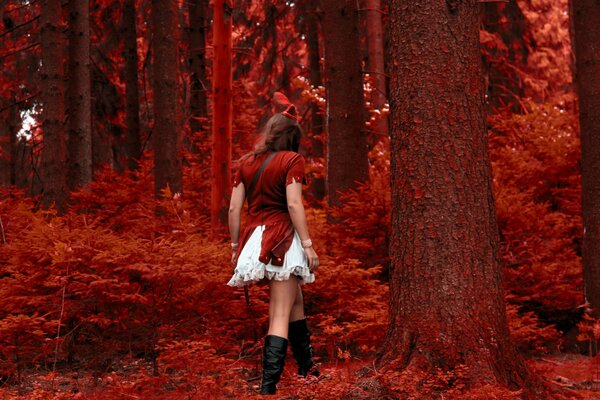 A girl on the background of a red forest