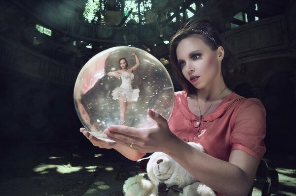 A magic ball with a ballerina in her hands