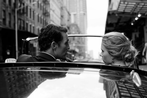 Black and white photo of lovers in the car