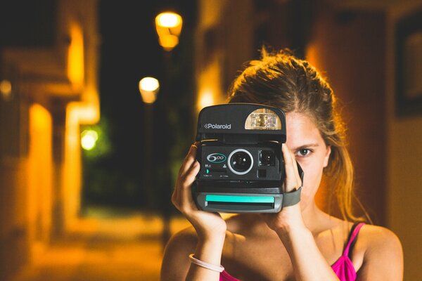 Belle fille avec un appareil photo dans la rue