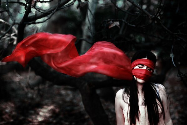 A girl with a red scarf wrapped around her mouth