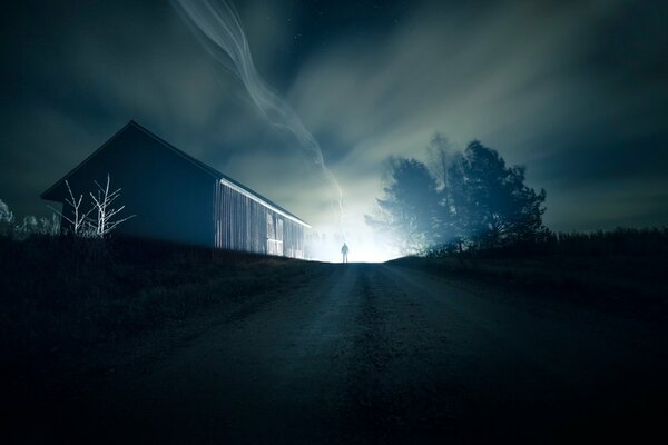 Silhouette of a man from afar on a night road