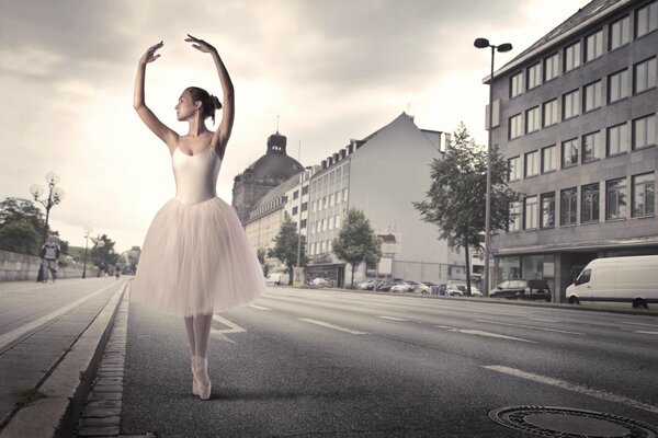 A ballerina stands on the street of a deserted city