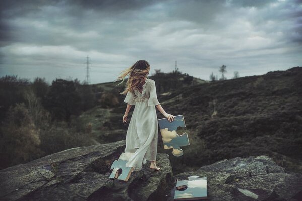 A girl collecting puzzles on stones